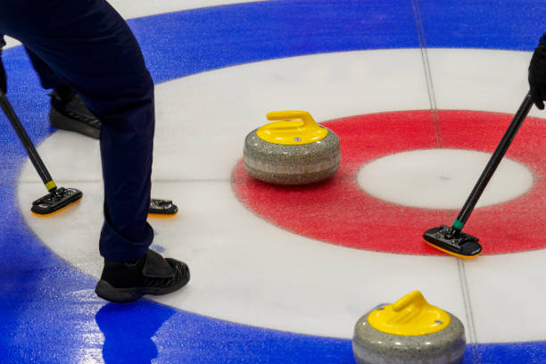 istock Curling stone being swept into the house 1806665436