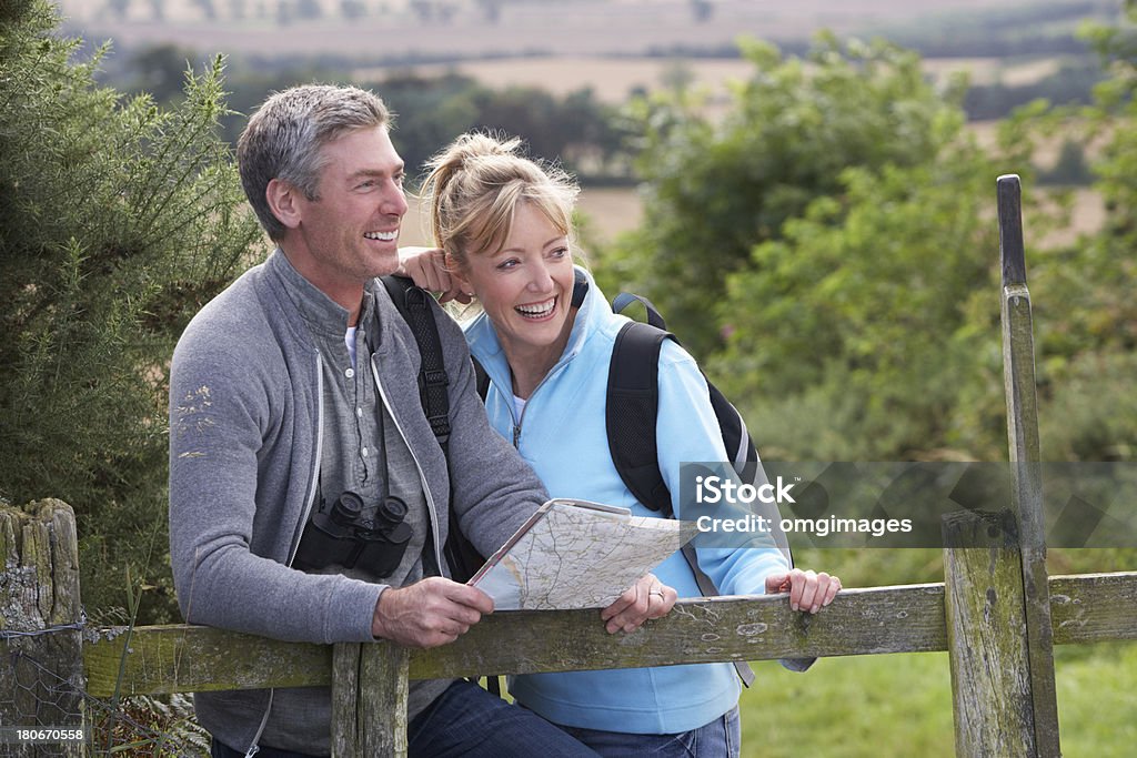 Mature white couple on a walk in the country Mature Couple On Country Walk Looking At Map Mature Couple Stock Photo