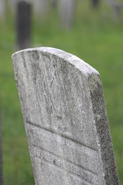 Cemetery Single Leaning Grave Stone stock photo