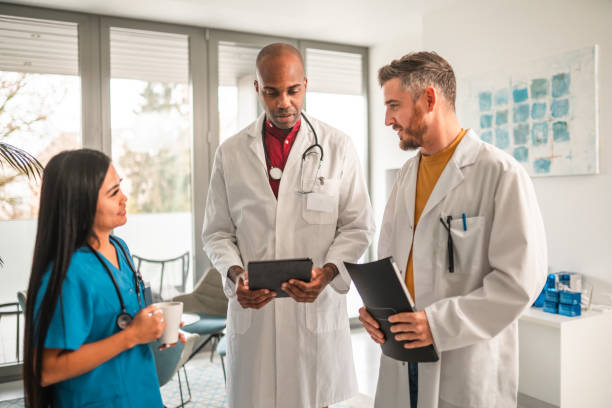 istock Handsome Multicultural Doctors Discussing With An Asian Female Nurse 1806732765