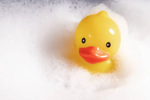 Toy duck in bathwater, Yellow toy duck, baby's bath companion, rubber ducky
