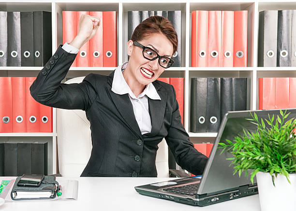 istock Angry business woman wants to break computer 180675824