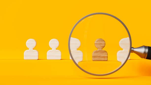 istock Five professional profiles reviewed by a magnifying glass on orange stage, human resources and labor 1806782851
