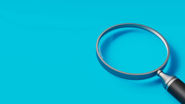 istock Metal magnifying glass on blue table, search and focus theme, 3d illustration 1806784263