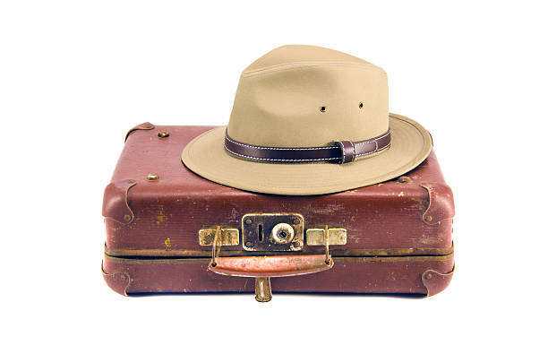 istock old aged suitcase for traveling and hat isolated on white 180678689