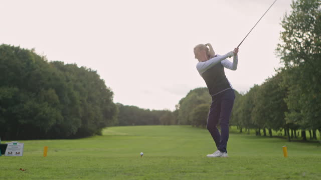 Woman, stroke and training for golf, recreation and lawn in outdoors, practice and performance or fitness. Coach, athlete and lesson or advice, exercise and practice a technique, teaching and helping