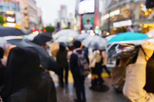 defocused photo of a crowd crossing the famous Shibuya Crossing in Tokyo, Japan