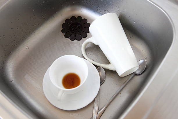 istock Dishwashing. White dishes in the kitchen sink. 180683285