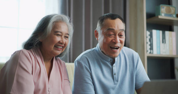 istock Relaxed mature old 60s couple using a computer laptop to play social media 1806833973