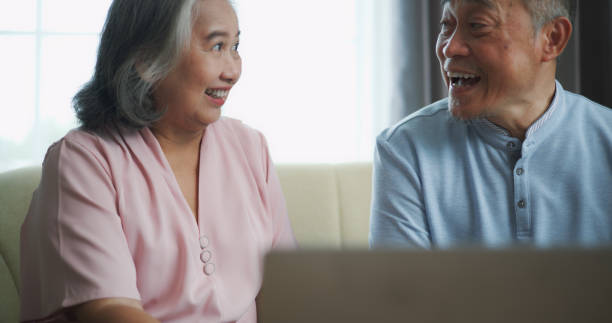 istock Relaxed mature old 60s couple using a computer laptop to play social media 1806833974