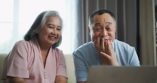 istock Relaxed mature old 60s couple using a computer laptop to play social media 1806833978