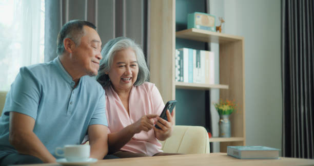 istock Relaxed mature old 60s couple using a computer laptop to play social media 1806835525