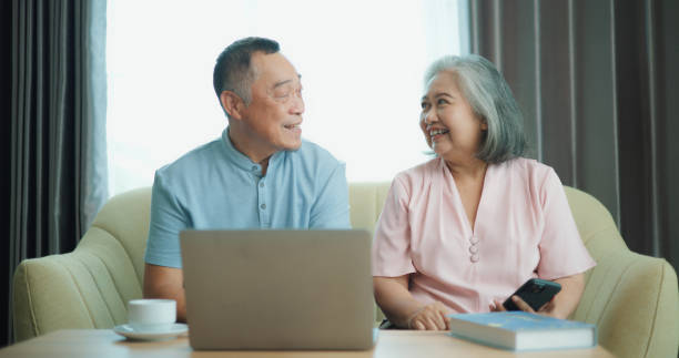 istock Relaxed mature old 60s couple using a computer laptop to play social media 1806837049