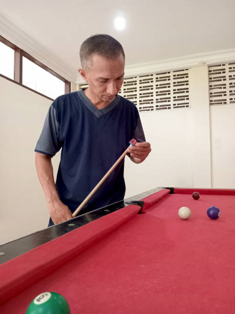 Asian man has a hobby of playing pool.