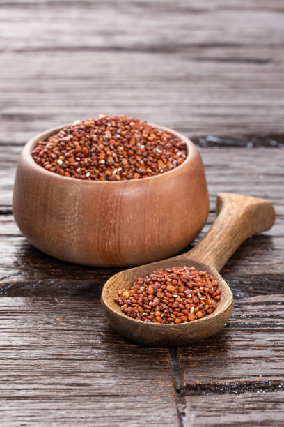 istock Raw red quinoa seeds in spoon and bowl - Chenopodium quinoa 1806893531