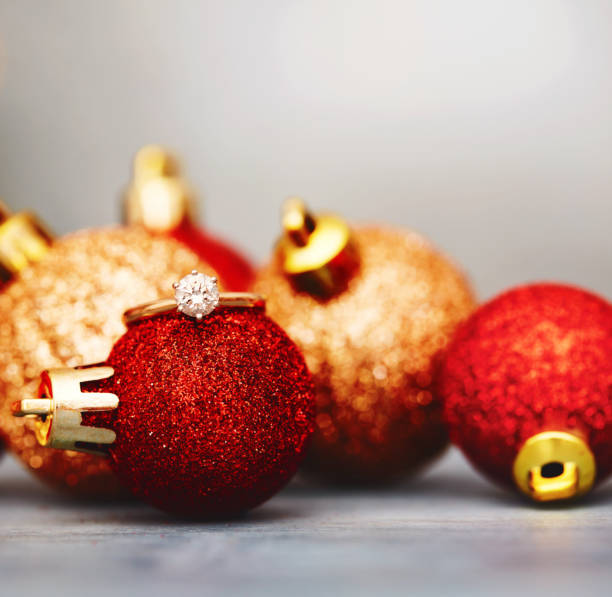 istock Engagement ring on a red Christmas ornament 1806909601