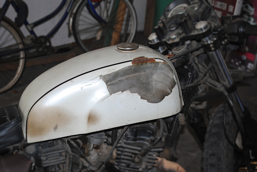 An old and worn out motorbike tanks.