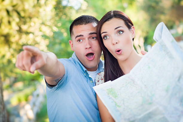 istock Mixed Race Couple Looking Over Map Outside Together 180692798