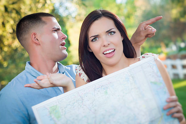 istock Lost and Confused Mixed Race Couple Looking Over Map Outside 180692838