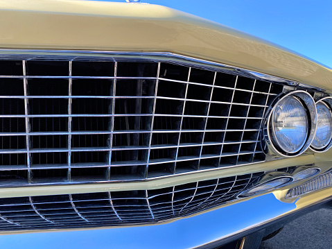 Fancy turquoise vintage retro car attracting the attention of visitors and amateurs of antiquity not only in the car\