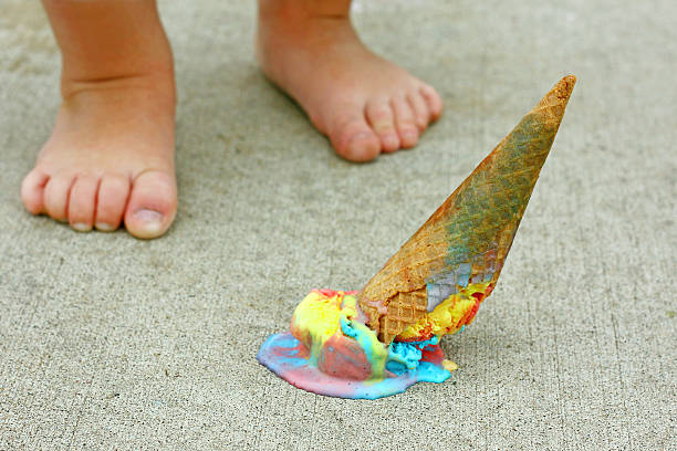 Toddler drops rainbow ice cream cone by feet