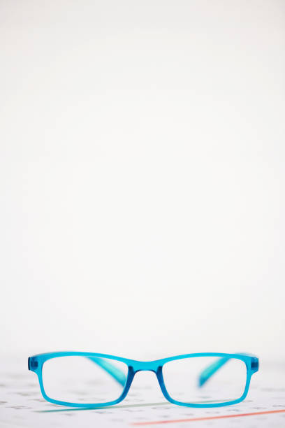 Bright image of eyeglasses and an eye chart with space for text