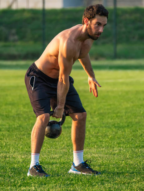 istock Athlete, man on green grass field doing exercise with 1806937010