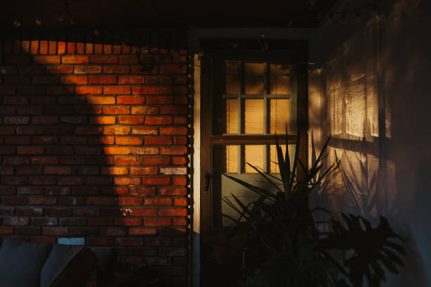 istock Sunset on side of building with sun reflecting on windows 1806941766