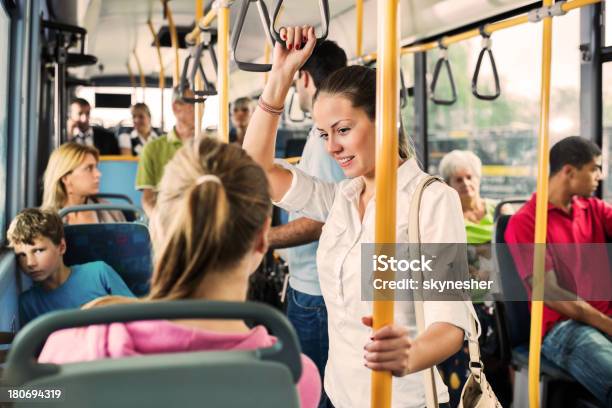 Young Woman Talking To Her Friend On Bus Stock Photo - Download Image Now - Bus, Inside Of, Women