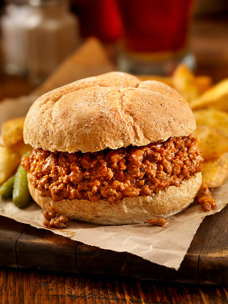 Sloppy Joe Sloppy Joe with Wedge Cut Fries and a Beer-Photographed on Hasselblad H3D2-39mb Camera sloppy joes stock pictures, royalty-free photos & images