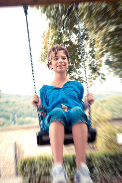 istock Girl going on a swing outdoor 180694398