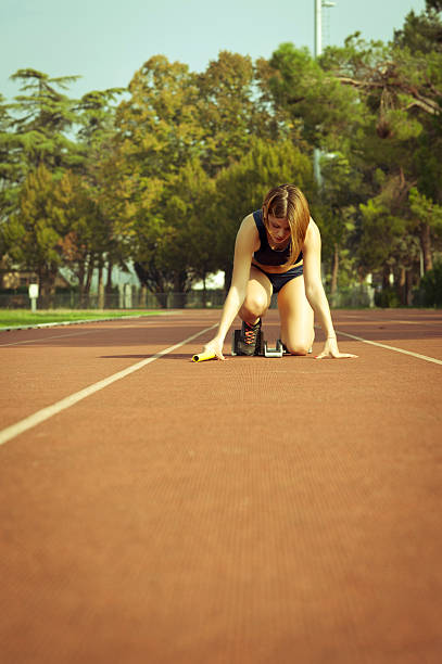 istock Young woman ready for a running race 180694444