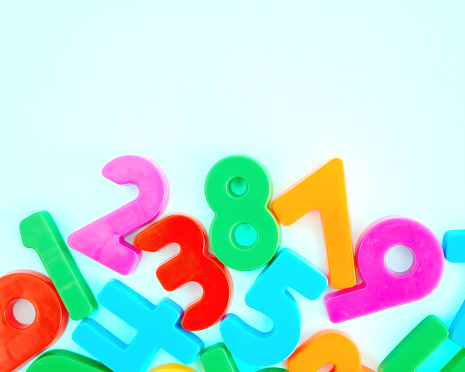 An assortment of brightly colored numbers on a blue background with space for text