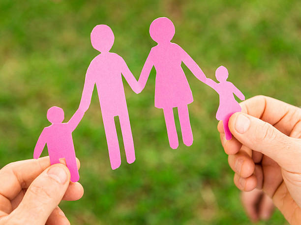 istock Holding a paper doll family 180694867