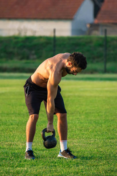 istock Athlete, man on green grass field doing exercise with 1806948689