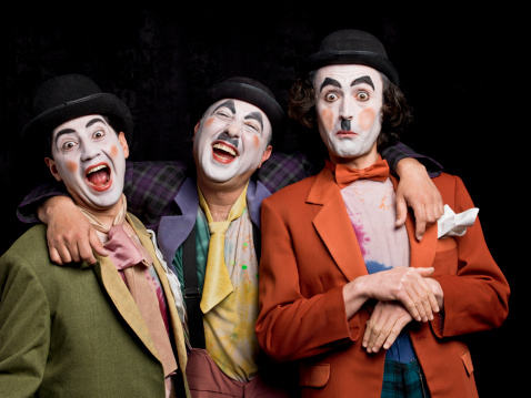 Three male mimes acting on the stage