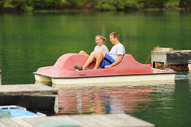 istock Siblings enjoying pedal boat 180695139