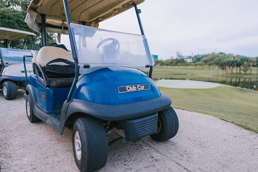 Golf cart high centered on a dirt mound