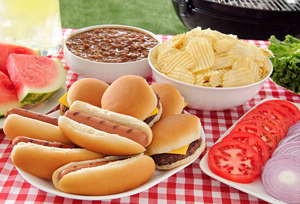 Picnic "Picnic - Cheeseburgers, hotdogs and large assortment of side items.  Please see my portfolio for other food related images." tailgate party photos stock pictures, royalty-free photos & images