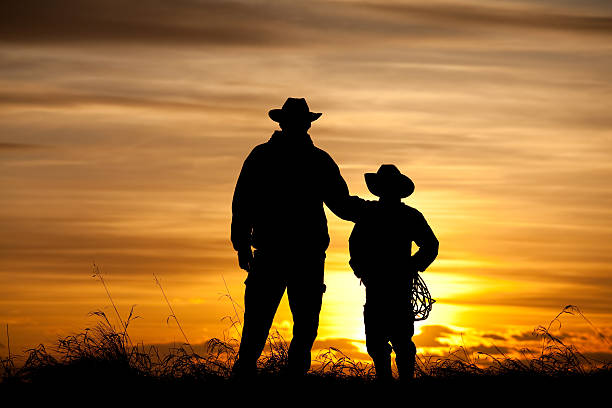 istock Father and Son Cowboy Silhouette 180695973