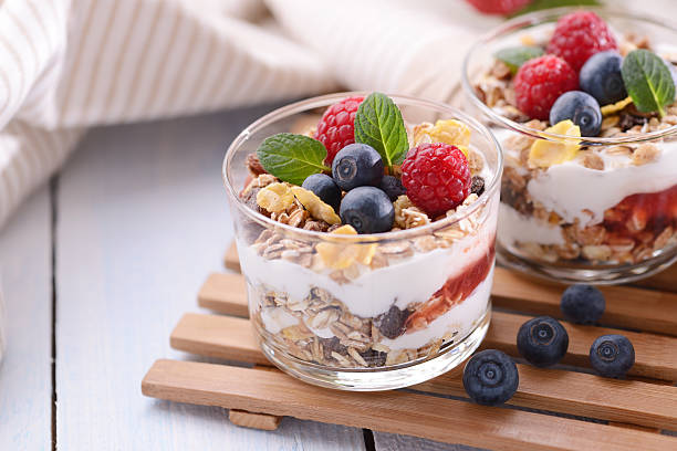 Parfait with yogurt,strawberry sauce,granola and fresh fruits "Parfait with yogurt,strawberry sauce,granola and fresh fruits" yogurt parfait stock pictures, royalty-free photos & images