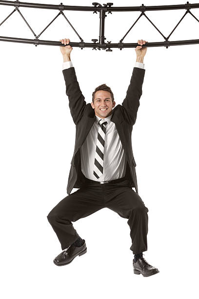 istock Businessman hanging from a metal structure 180696293
