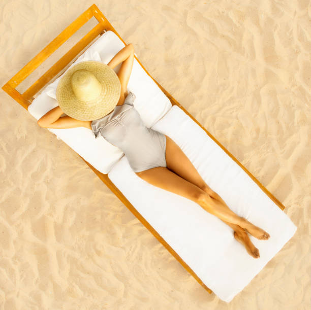 istock Woman sun bathing at the beach 180696312