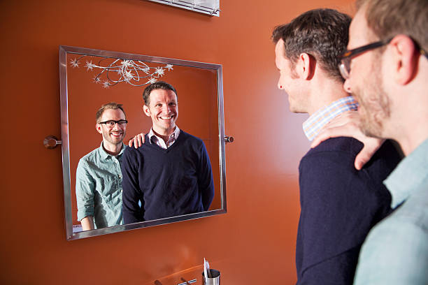 istock Gay couple looking in mirror 180696367