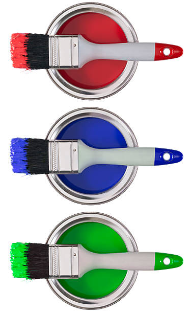 istock Three paintbrushes on tins of red, blue and green paint 180696672