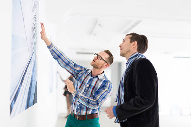 istock Artist Showing Gallery Owner His Work 180696691