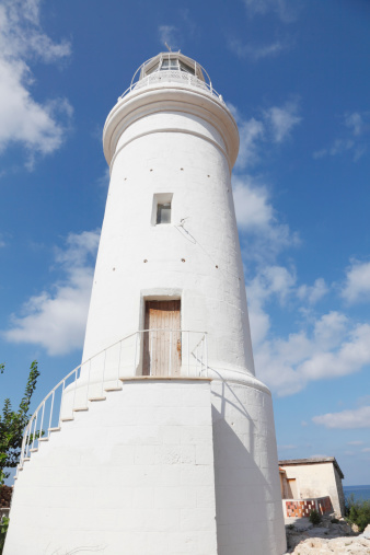Paphos white lighthouse in archaeological site Cyprus against sky