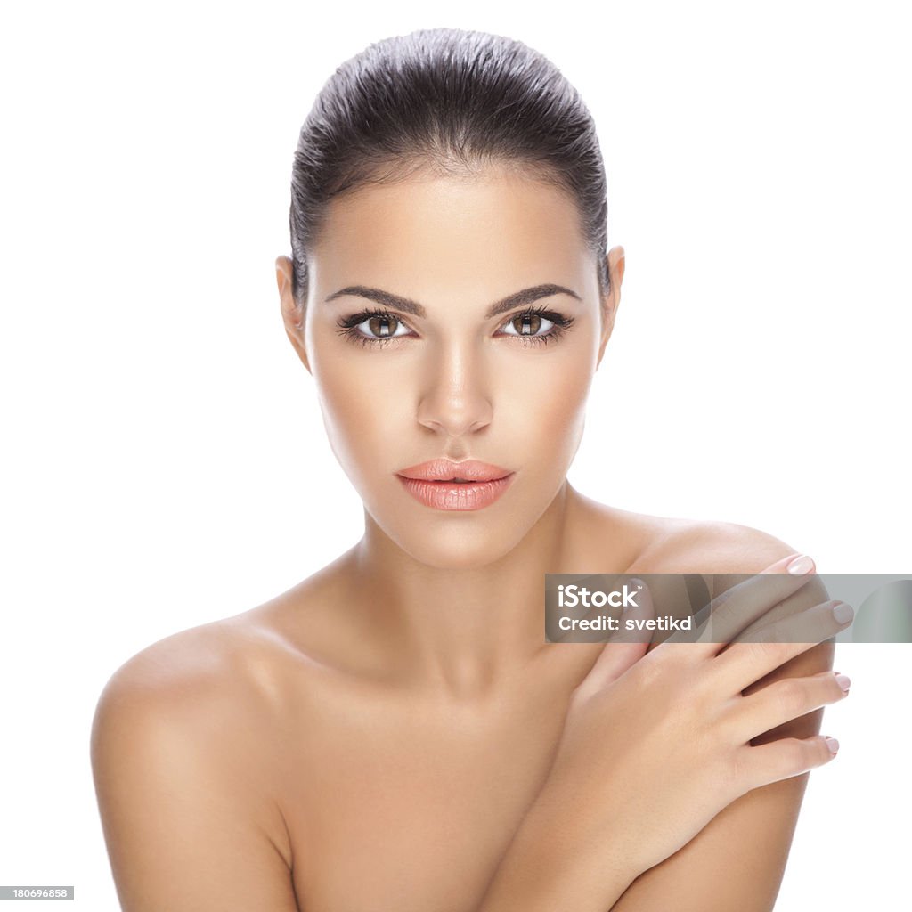 Beauty. Close-up portrait of a beautiful brunette holding hand on her shoulder and looking at camera.See more BEAUTY images of this MODEL. For lightbox click any image below. 20-29 Years Stock Photo