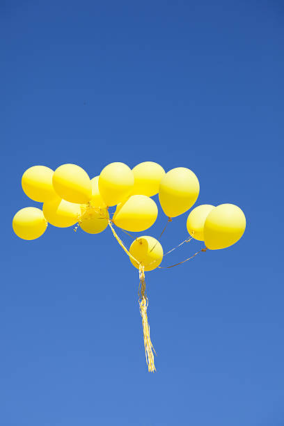 istock Yellow balloons in the sky 180697003