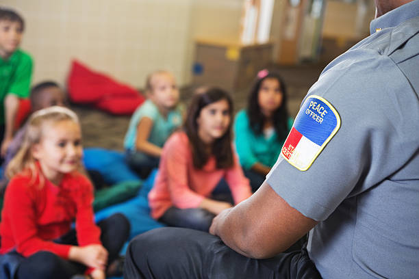 istock peace officer teaching children about something 180697141